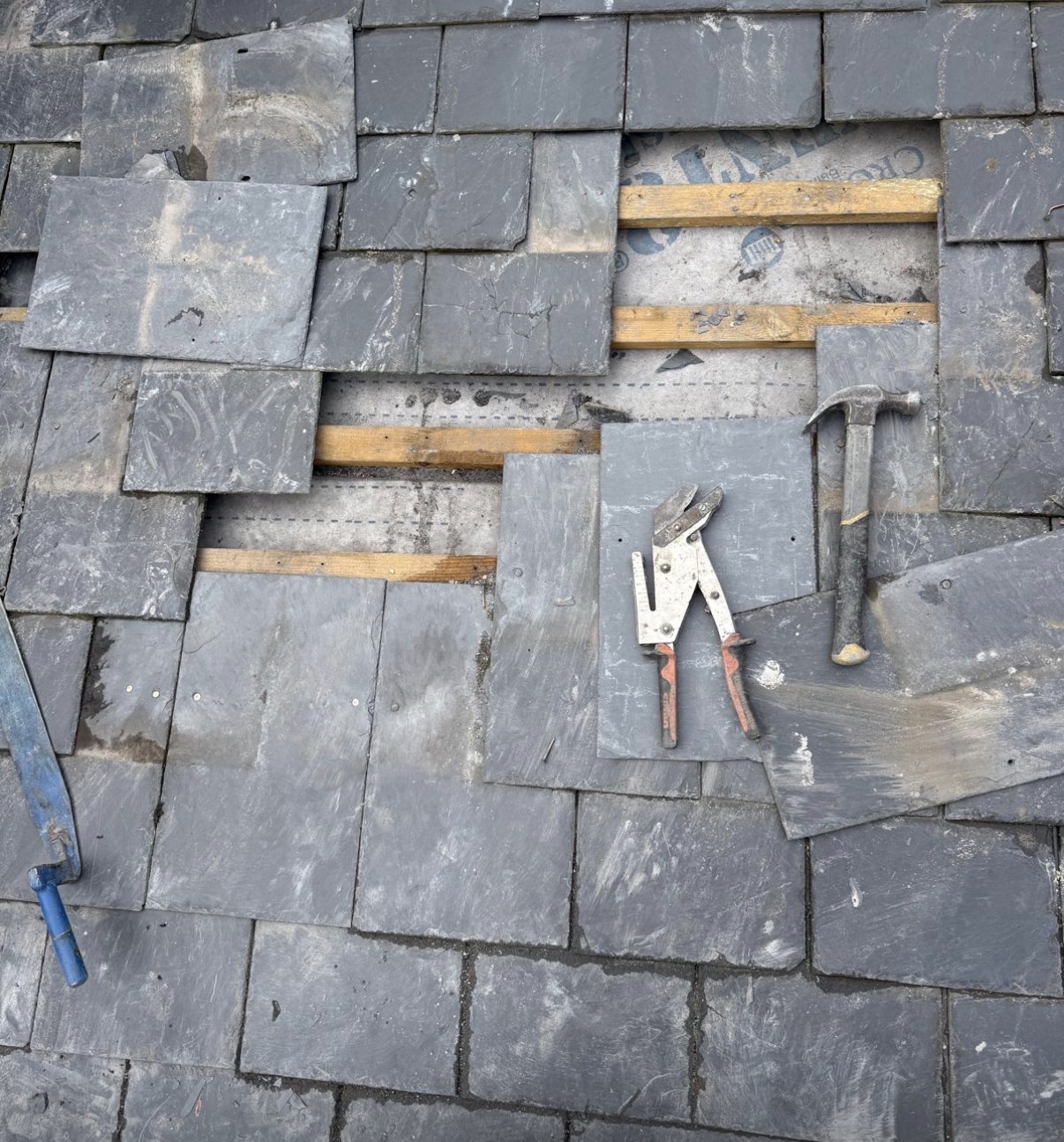 Roof repair work in progress on a residential roof